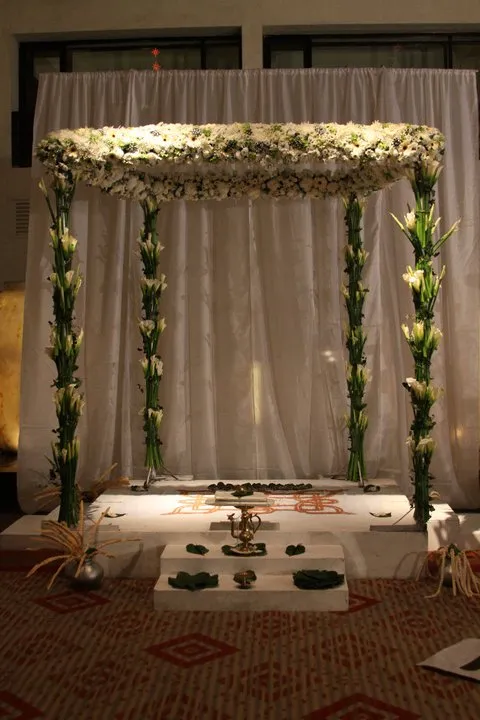 Futuristic roller coaster inside a vibrant, neon-lit indoor amusement park.