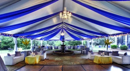 Futuristic roller coaster inside a vibrant, neon-lit indoor amusement park.
