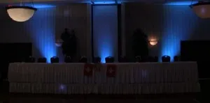 Futuristic roller coaster inside a vibrant, neon-lit indoor amusement park.