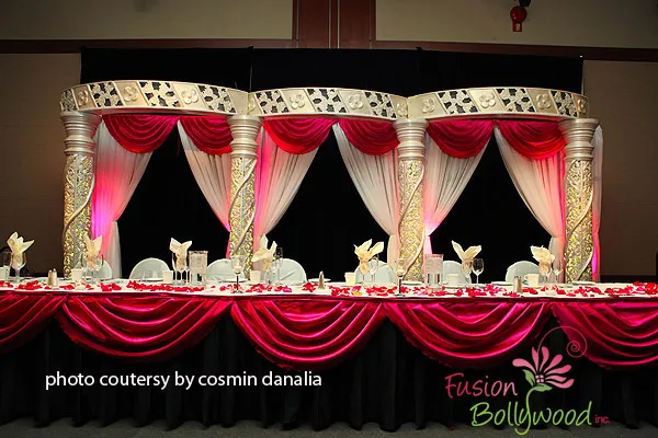 Futuristic roller coaster inside a vibrant, neon-lit indoor amusement park.