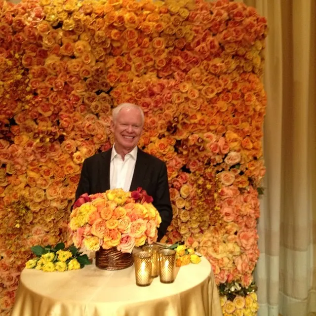 Futuristic roller coaster inside a vibrant, neon-lit indoor amusement park.