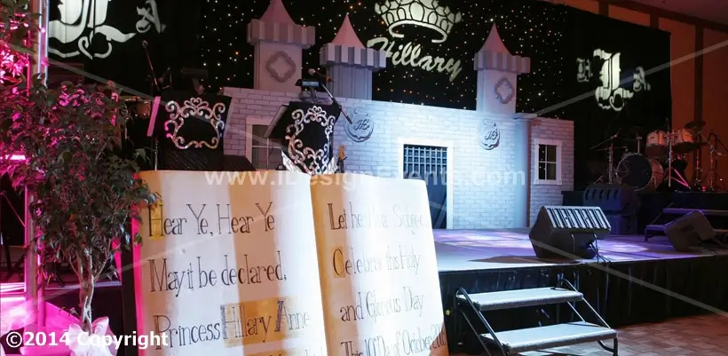 Futuristic roller coaster inside a vibrant, neon-lit indoor amusement park.