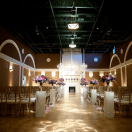 Elegant wedding ceremony setup with chandeliers and floral arrangements.