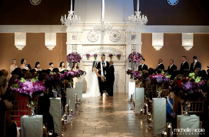 Elegant wedding ceremony setup with chandeliers and floral arrangements.