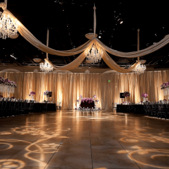 Elegant wedding ceremony setup with chandeliers and floral arrangements.