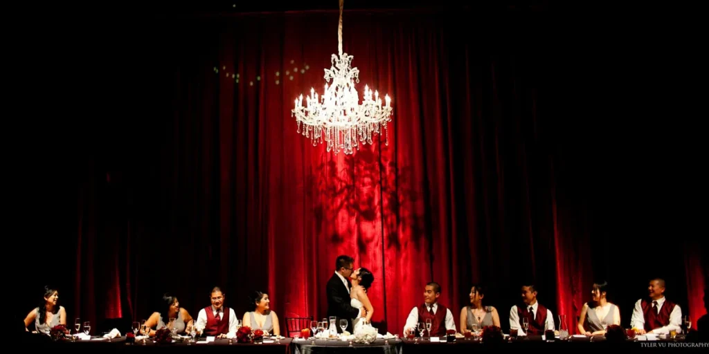 Elegant wedding ceremony setup with chandeliers and floral arrangements.