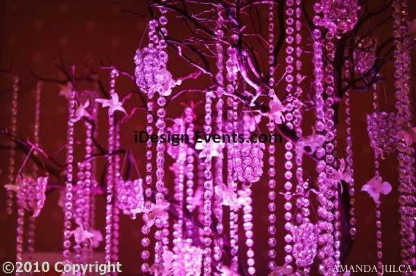Futuristic roller coaster inside a vibrant, neon-lit indoor amusement park.