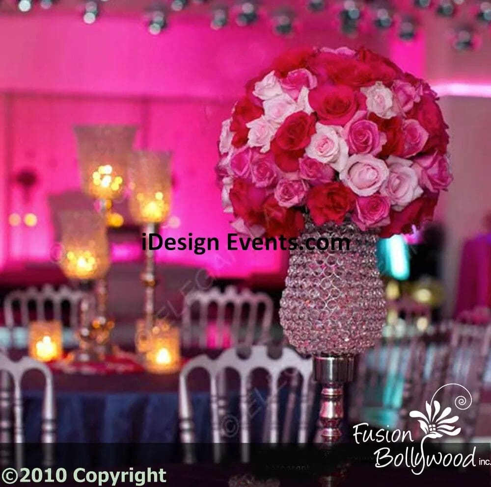 Elegant event table centerpiece with pink roses and sparkling decor.