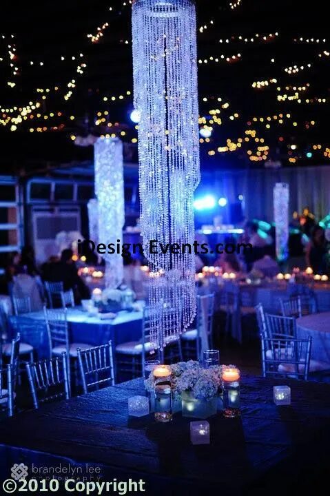 Futuristic roller coaster inside a vibrant, neon-lit indoor amusement park.