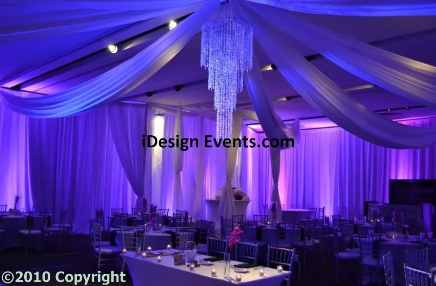 Futuristic roller coaster inside a vibrant, neon-lit indoor amusement park.