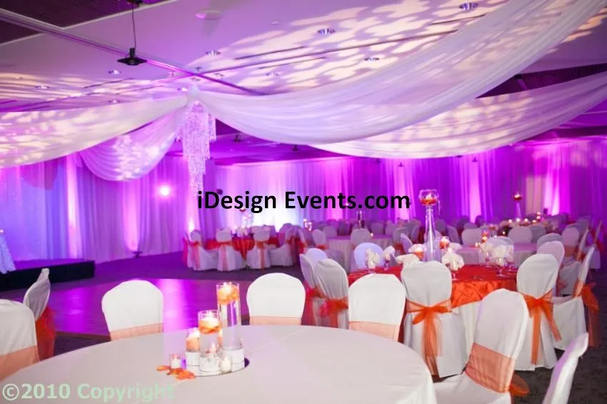 Futuristic roller coaster inside a vibrant, neon-lit indoor amusement park.