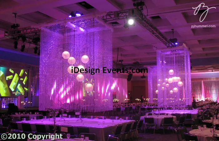 Futuristic roller coaster inside a vibrant, neon-lit indoor amusement park.