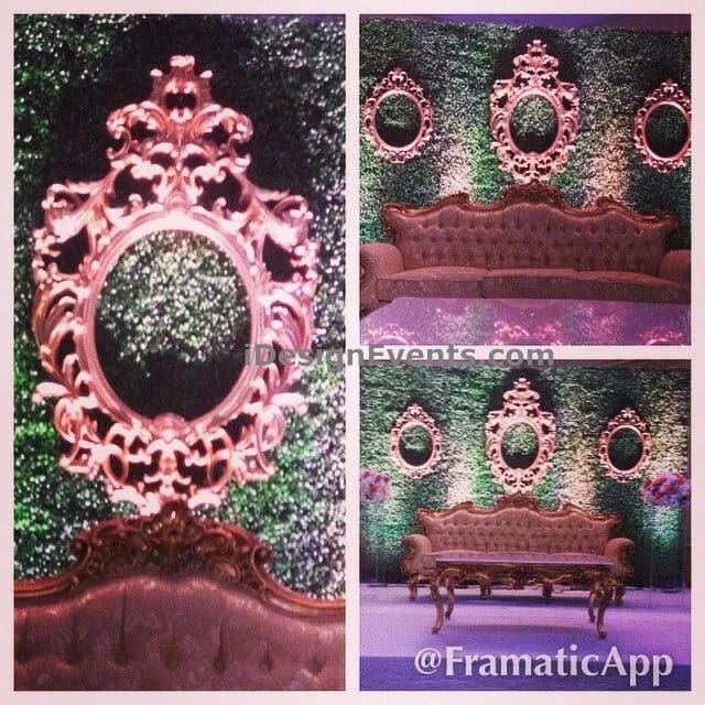 Ornate pink wall decor with a bench covered in green foliage.