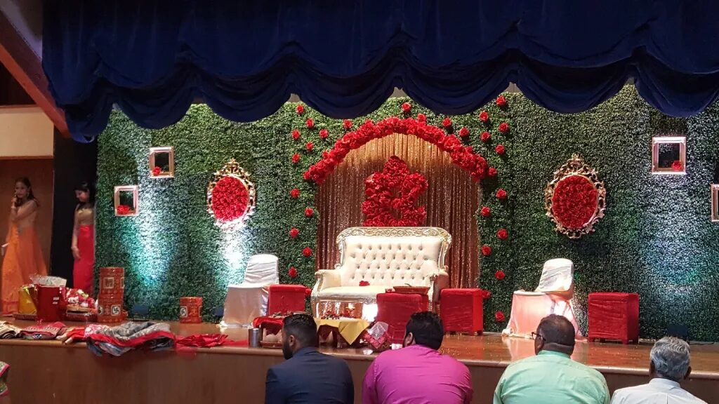 Futuristic roller coaster inside a vibrant, neon-lit indoor amusement park.