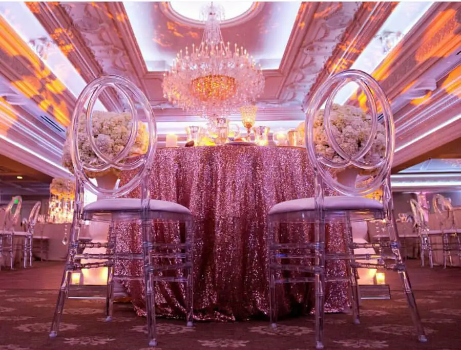 Futuristic roller coaster inside a vibrant, neon-lit indoor amusement park.