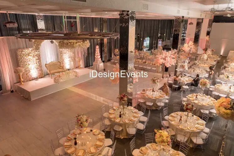 Elegant draped curtains in warm colors with a central tieback in a spacious room.