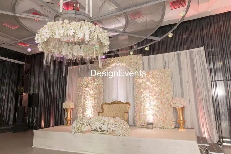 Elegant draped curtains in warm colors with a central tieback in a spacious room.