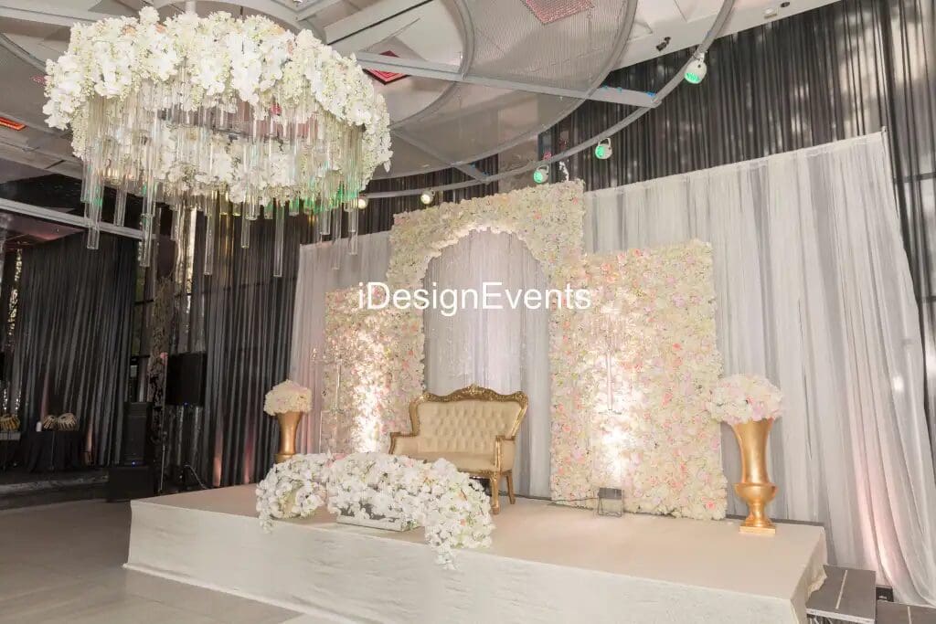 Elegant wedding stage with floral decorations and soft lighting.