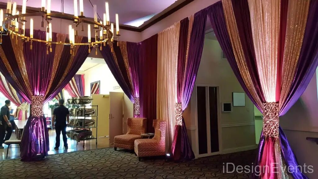 Futuristic roller coaster inside a vibrant, neon-lit indoor amusement park.