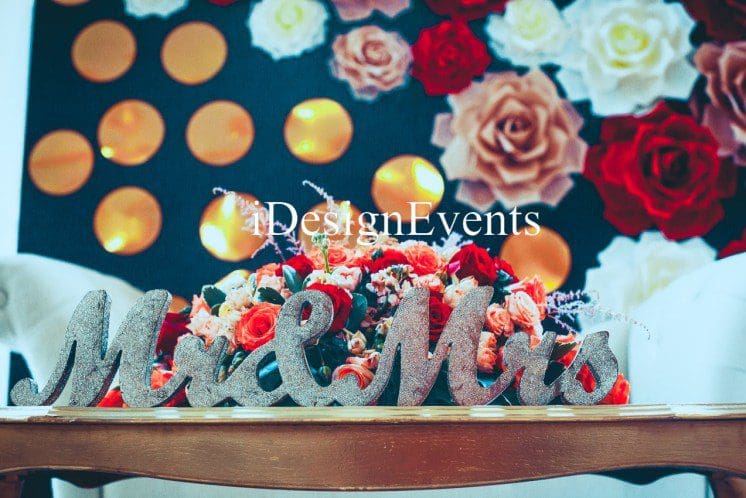 Futuristic roller coaster inside a vibrant, neon-lit indoor amusement park.