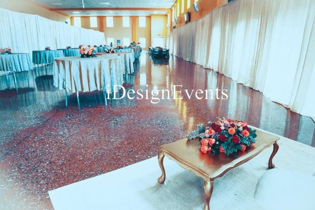 Futuristic roller coaster inside a vibrant, neon-lit indoor amusement park.