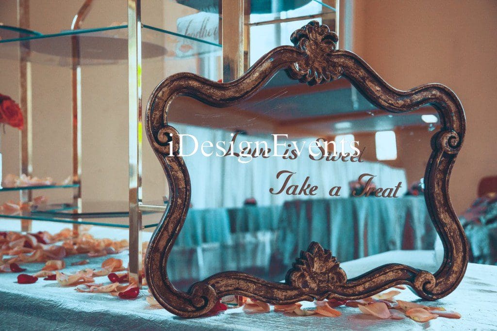 Futuristic roller coaster inside a vibrant, neon-lit indoor amusement park.