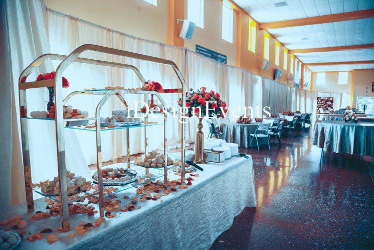 Futuristic roller coaster inside a vibrant, neon-lit indoor amusement park.