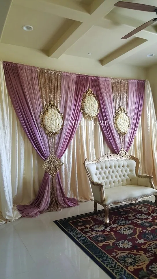 Futuristic roller coaster inside a vibrant, neon-lit indoor amusement park.