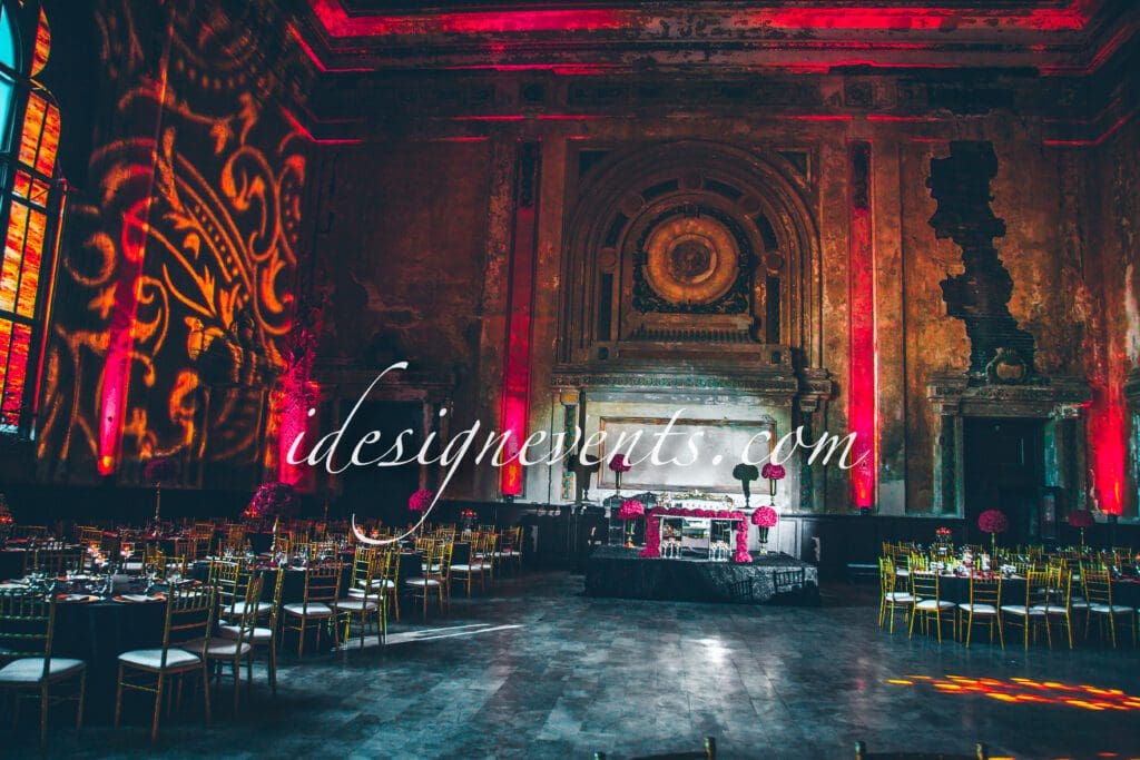 Futuristic roller coaster inside a vibrant, neon-lit indoor amusement park.