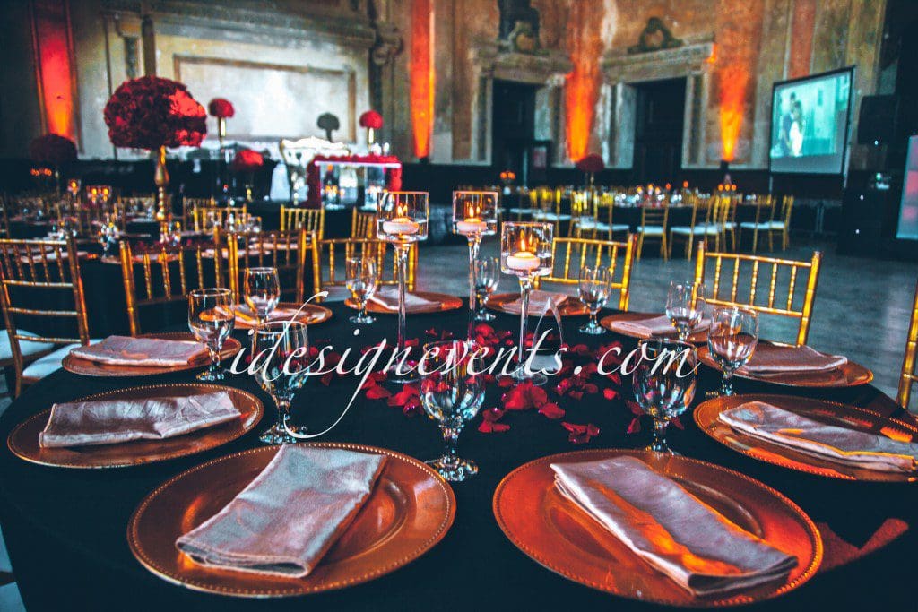 Futuristic roller coaster inside a vibrant, neon-lit indoor amusement park.
