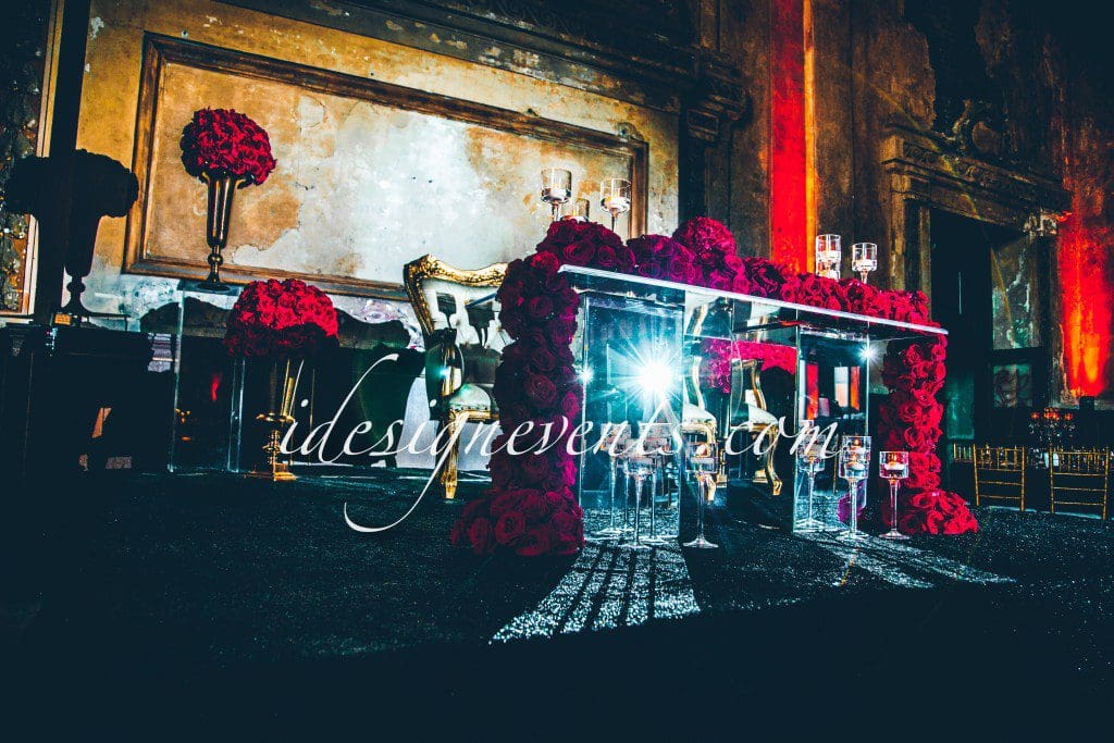 Futuristic roller coaster inside a vibrant, neon-lit indoor amusement park.