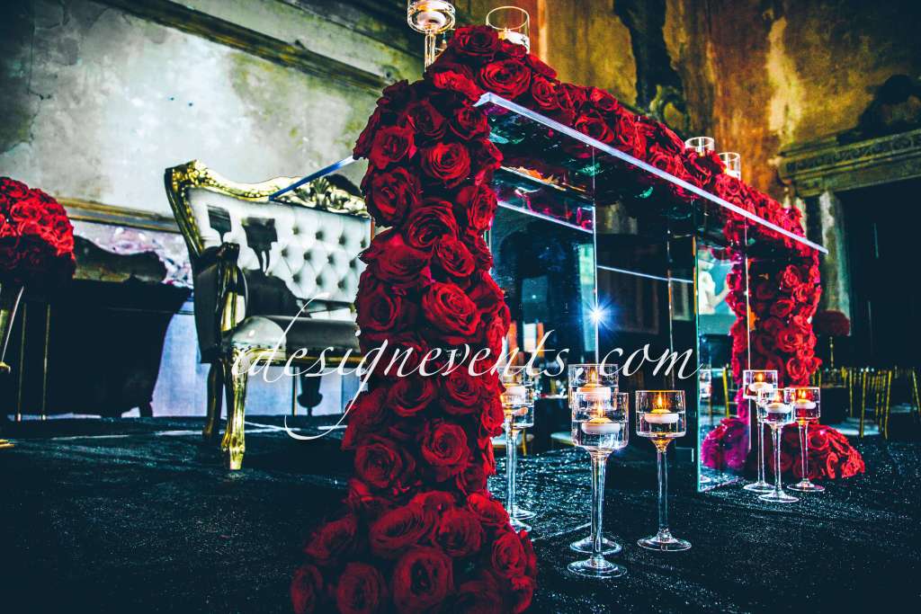 Futuristic roller coaster inside a vibrant, neon-lit indoor amusement park.