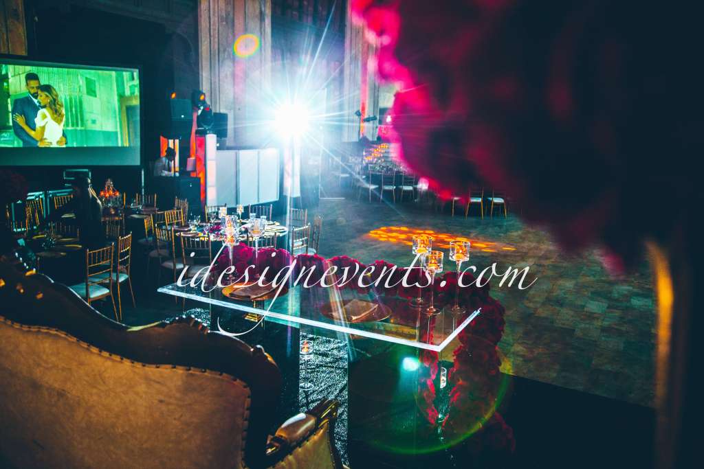 Futuristic roller coaster inside a vibrant, neon-lit indoor amusement park.
