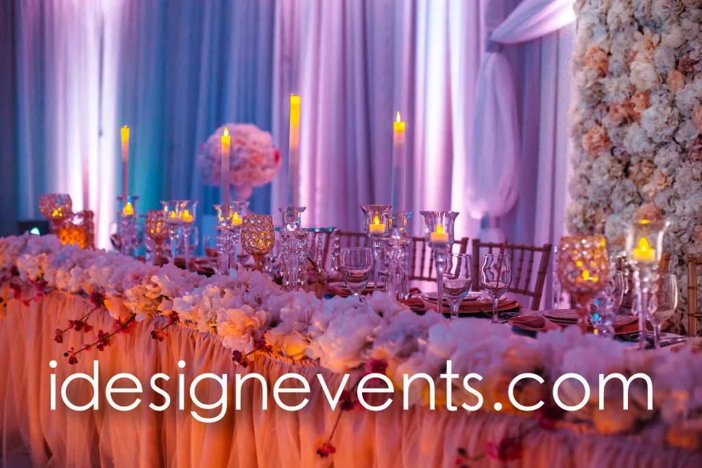 Futuristic roller coaster inside a vibrant, neon-lit indoor amusement park.