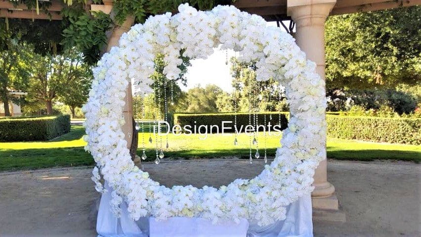 Futuristic roller coaster inside a vibrant, neon-lit indoor amusement park.