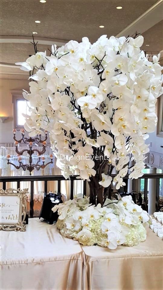 Futuristic roller coaster inside a vibrant, neon-lit indoor amusement park.