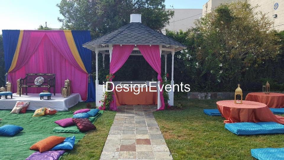 Futuristic roller coaster inside a vibrant, neon-lit indoor amusement park.