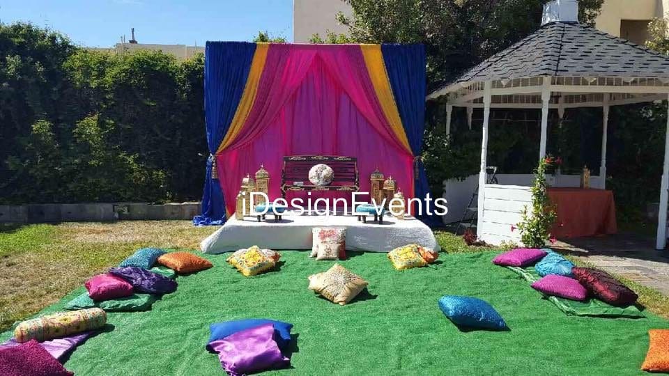 Futuristic roller coaster inside a vibrant, neon-lit indoor amusement park.