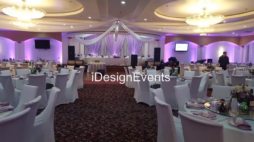 Futuristic roller coaster inside a vibrant, neon-lit indoor amusement park.