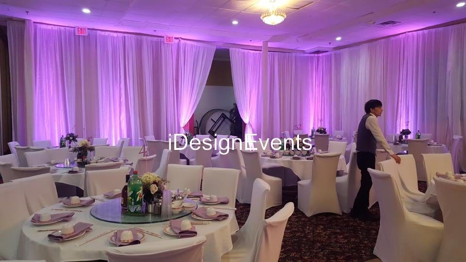 Futuristic roller coaster inside a vibrant, neon-lit indoor amusement park.