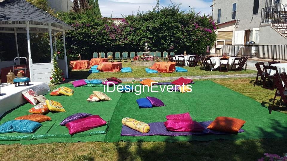 Futuristic roller coaster inside a vibrant, neon-lit indoor amusement park.