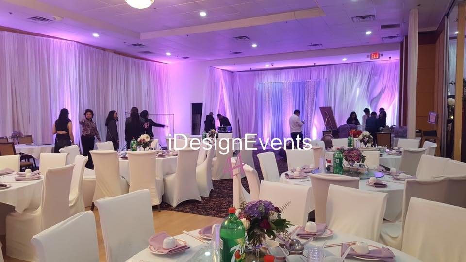 Futuristic roller coaster inside a vibrant, neon-lit indoor amusement park.