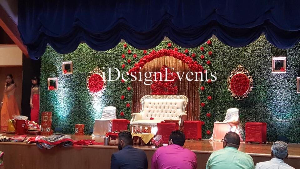 Futuristic roller coaster inside a vibrant, neon-lit indoor amusement park.