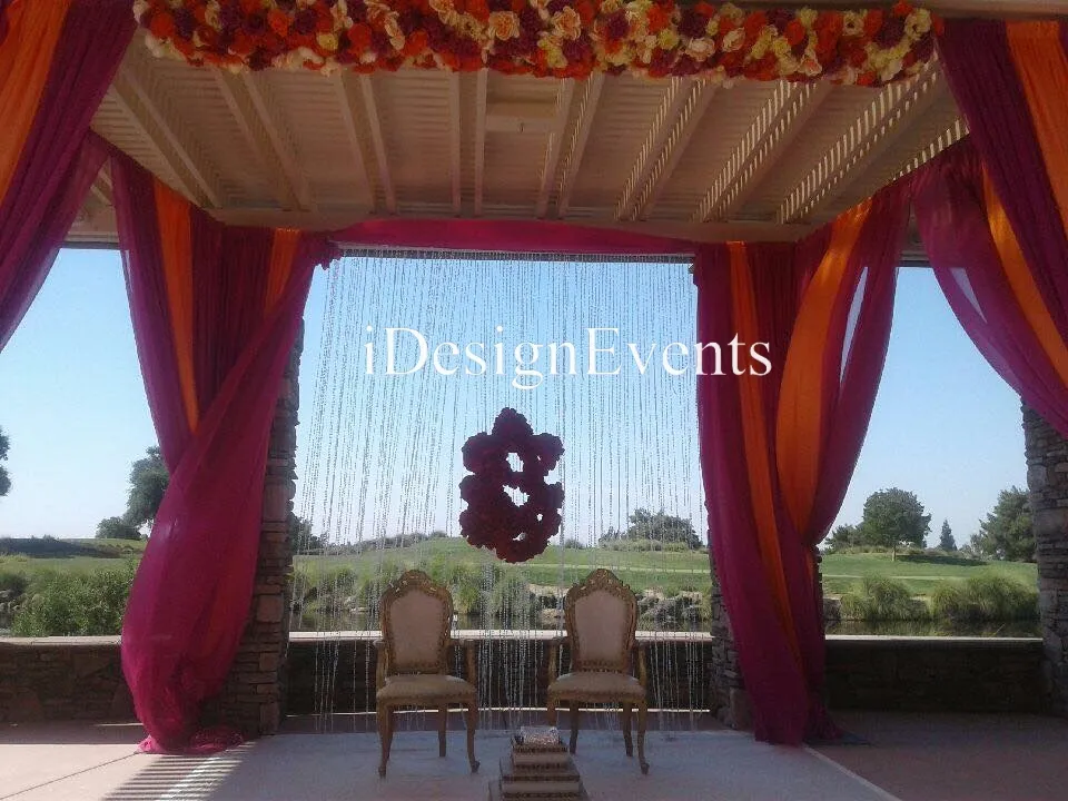 Futuristic roller coaster inside a vibrant, neon-lit indoor amusement park.