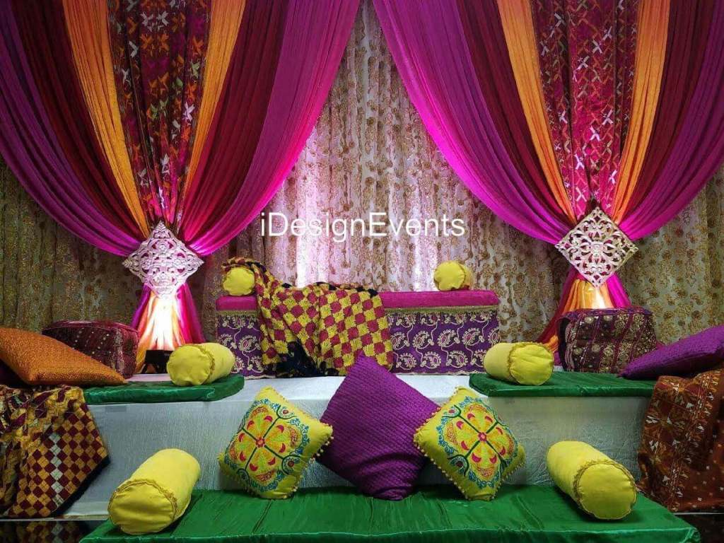 Futuristic roller coaster inside a vibrant, neon-lit indoor amusement park.