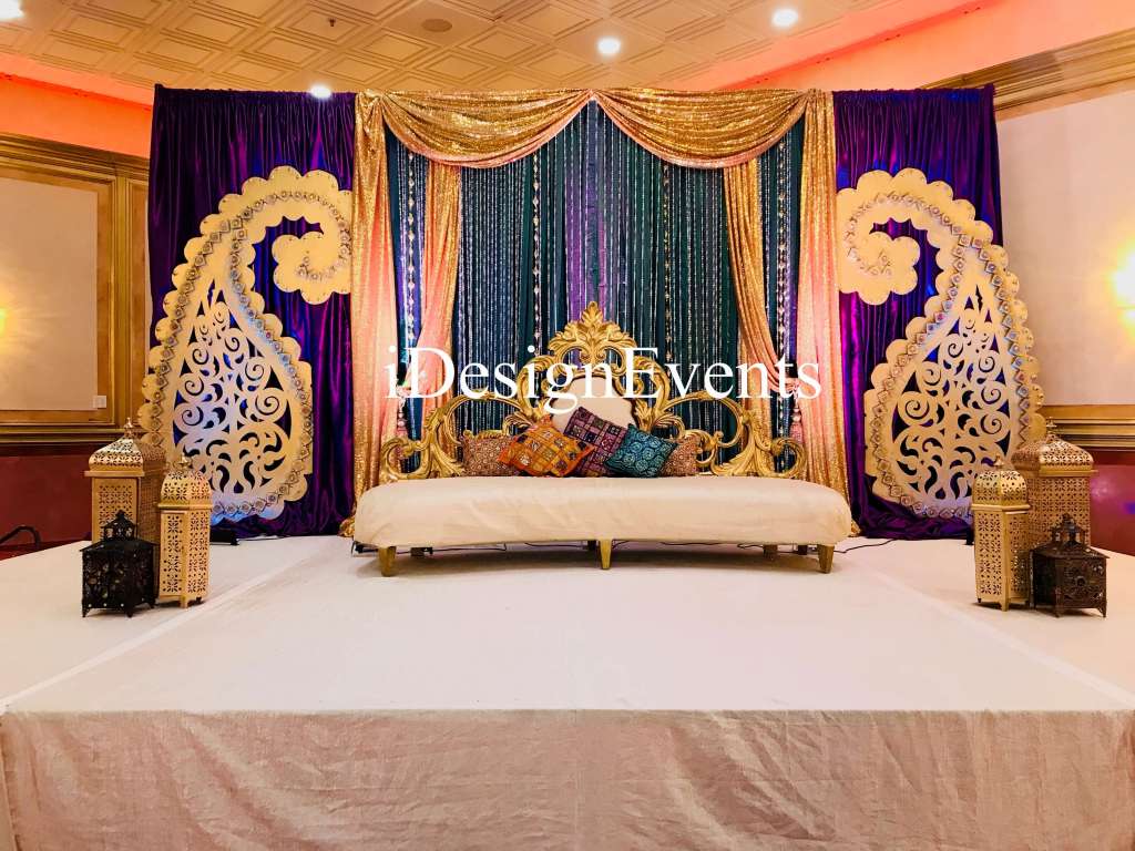Futuristic roller coaster inside a vibrant, neon-lit indoor amusement park.