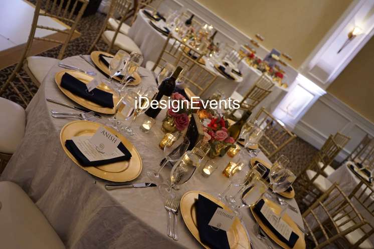 Futuristic roller coaster inside a vibrant, neon-lit indoor amusement park.