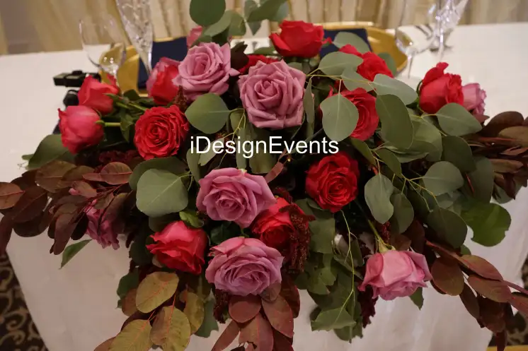 Futuristic roller coaster inside a vibrant, neon-lit indoor amusement park.