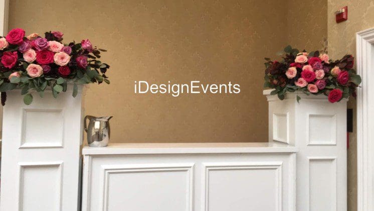 Futuristic roller coaster inside a vibrant, neon-lit indoor amusement park.