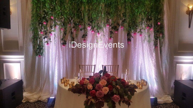 Futuristic roller coaster inside a vibrant, neon-lit indoor amusement park.